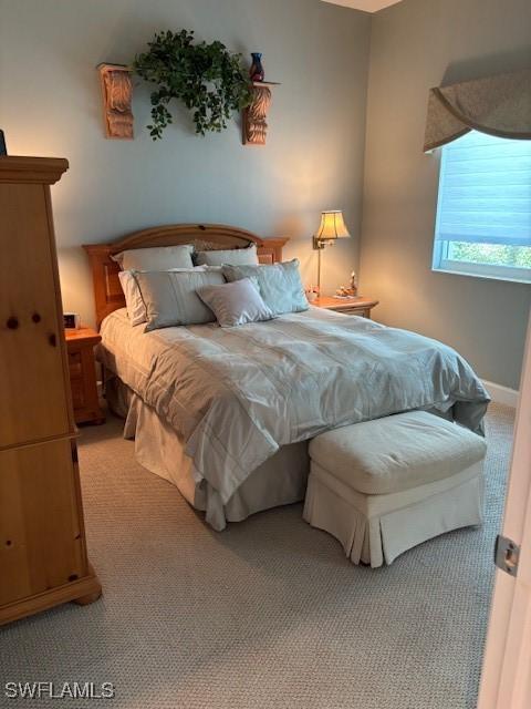 bedroom with light colored carpet