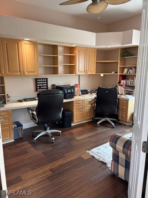 home office with ceiling fan, dark wood-style flooring, and built in study area