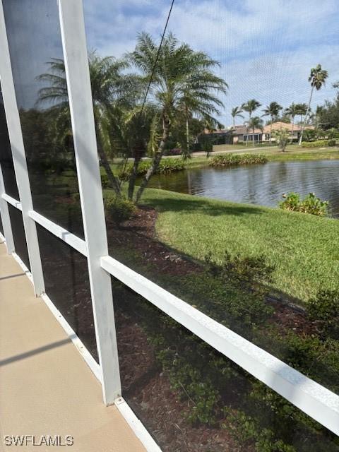 unfurnished sunroom featuring a water view