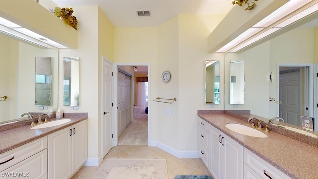 full bathroom with two vanities, visible vents, and a sink