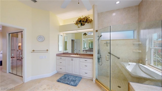 full bath featuring tile patterned floors, plenty of natural light, vanity, and a tile shower