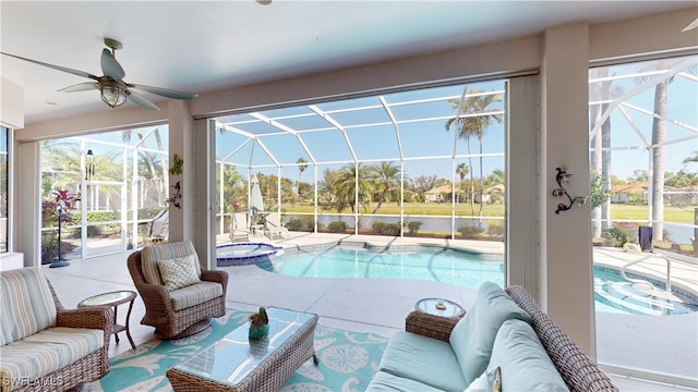 view of swimming pool featuring a pool with connected hot tub, ceiling fan, outdoor lounge area, a lanai, and a patio area