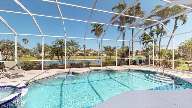 view of pool with glass enclosure, a pool with connected hot tub, and a patio area