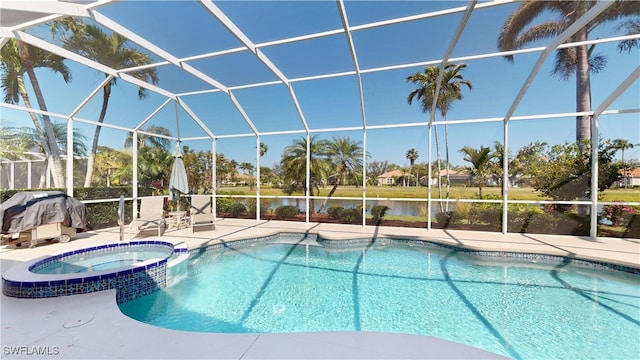 view of swimming pool with glass enclosure, a patio area, and a pool with connected hot tub