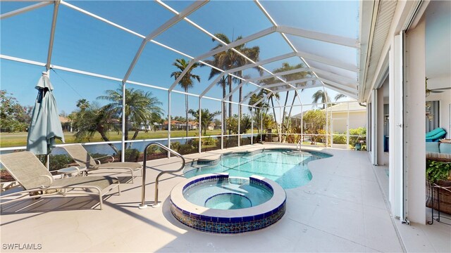 view of pool featuring glass enclosure, a patio, and a pool with connected hot tub