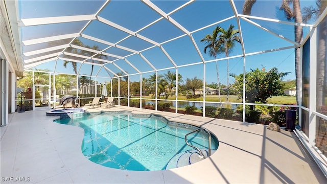 view of swimming pool featuring glass enclosure, a patio, and a pool with connected hot tub