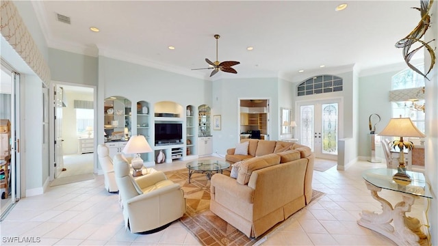 living area with light tile patterned floors, visible vents, ceiling fan, and ornamental molding