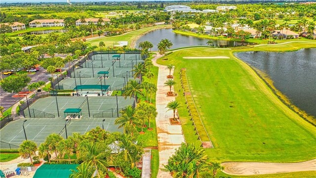 drone / aerial view with a water view and golf course view