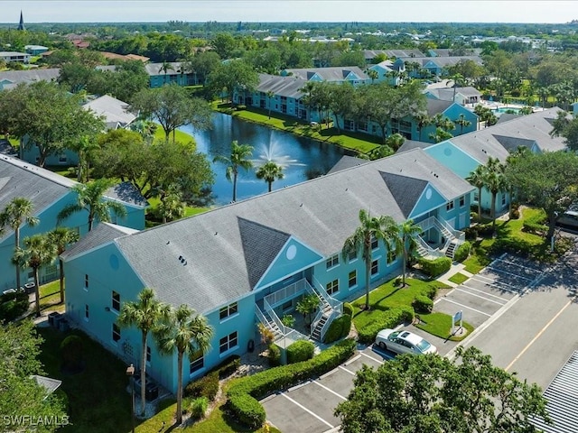 drone / aerial view with a water view and a residential view