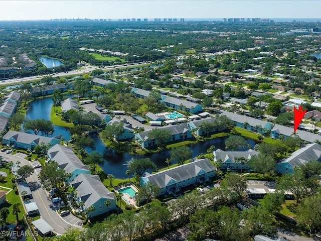 drone / aerial view featuring a water view and a residential view