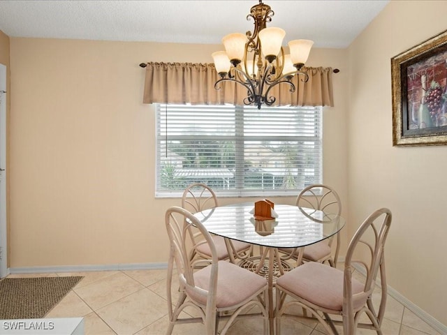 dining area featuring light tile patterned floors, baseboards, and an inviting chandelier