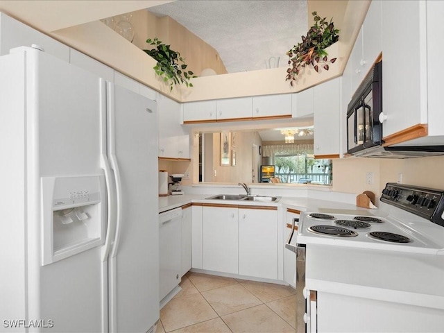 kitchen with white appliances, light countertops, a sink, and white cabinets