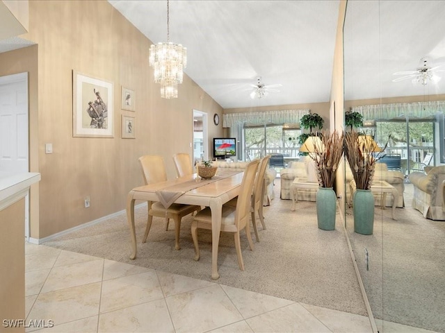 dining area with lofted ceiling, light tile patterned floors, baseboards, and ceiling fan with notable chandelier