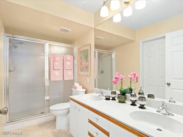 full bathroom featuring double vanity, visible vents, a sink, and tile patterned floors