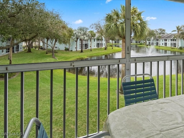 balcony featuring a residential view and a water view