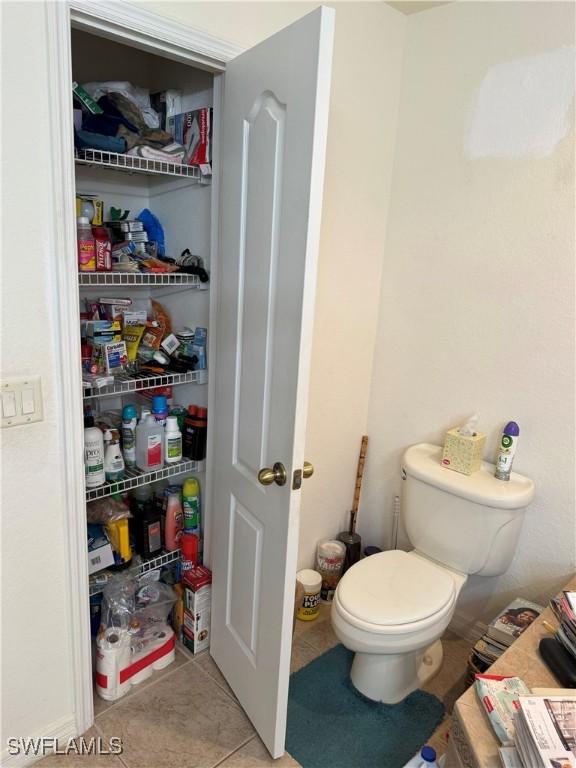 bathroom featuring toilet and tile patterned floors