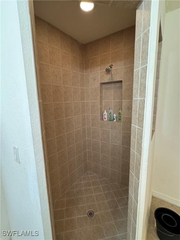 bathroom with tiled shower