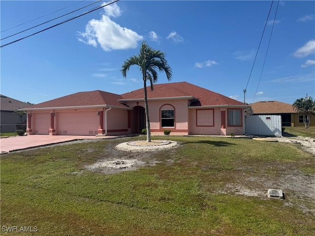 view of front of home with a front yard, concrete driveway, an attached garage, and stucco siding