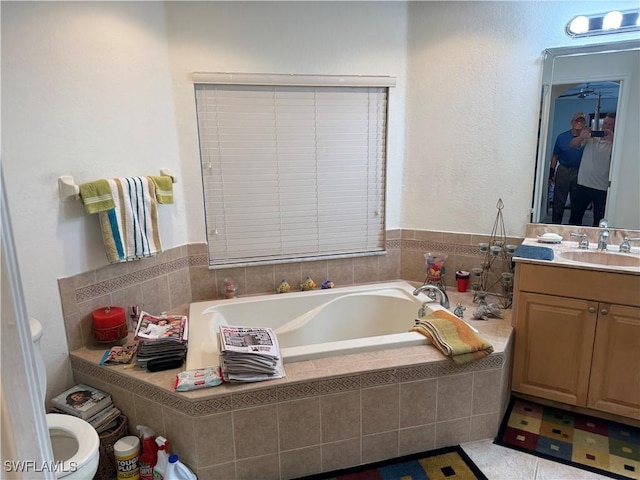 full bathroom with toilet, a bath, and vanity