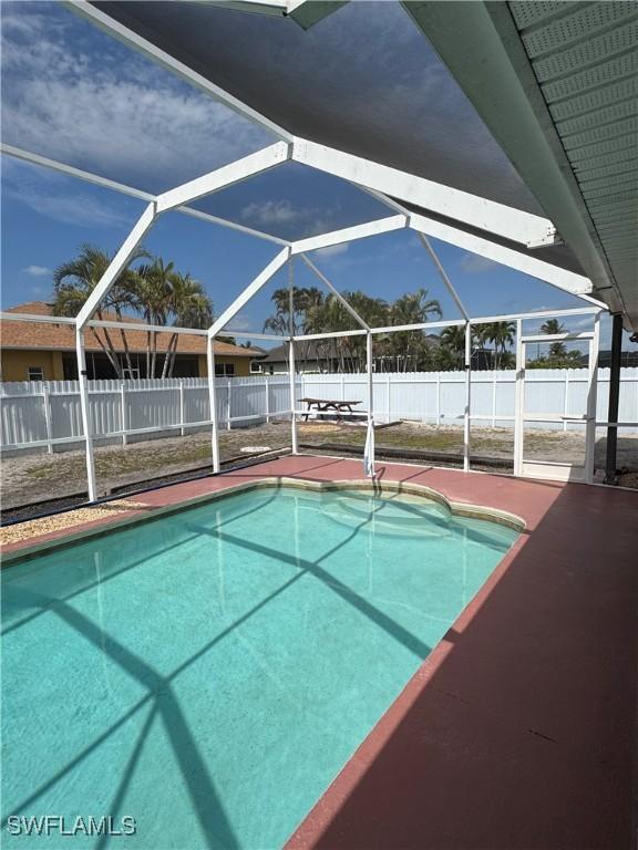 view of pool featuring a patio, a fenced backyard, a fenced in pool, and a lanai