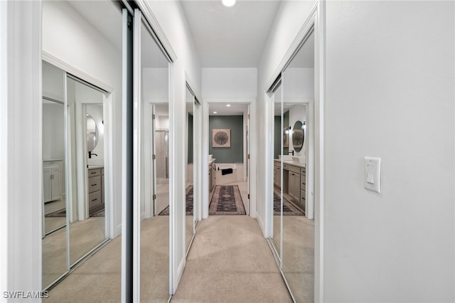 hallway featuring light carpet