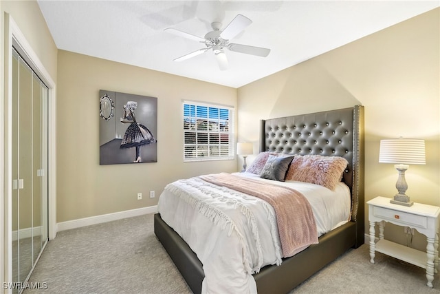 bedroom with ceiling fan, baseboards, a closet, and light colored carpet