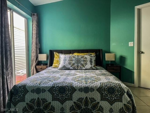 bedroom with multiple windows and tile patterned floors