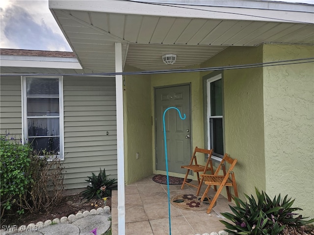 doorway to property with stucco siding