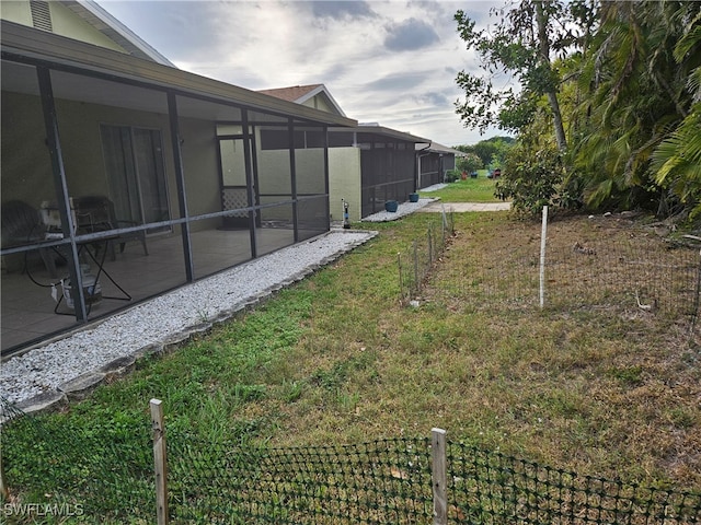 view of yard featuring a sunroom