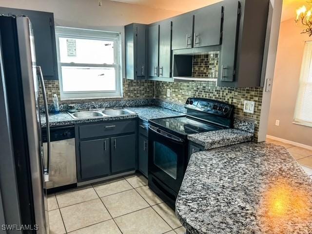 kitchen featuring light tile patterned floors, tasteful backsplash, stainless steel appliances, and a sink