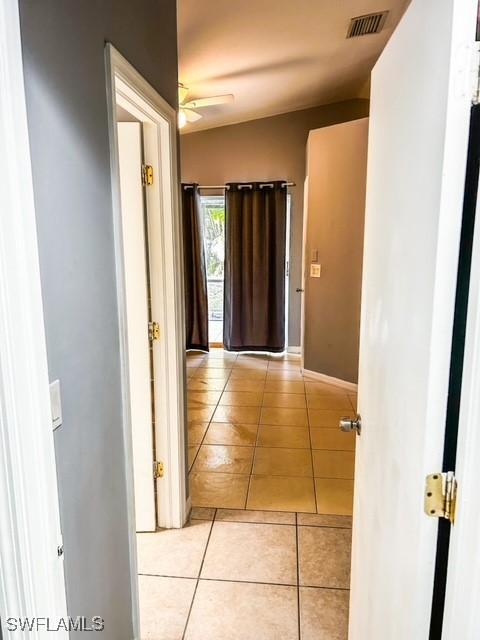 hallway with light tile patterned floors and visible vents