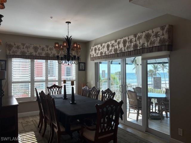 dining area with a notable chandelier and baseboards