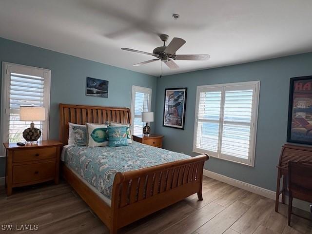 bedroom featuring baseboards, a ceiling fan, and wood finished floors