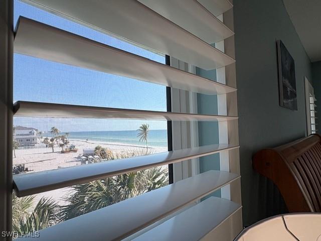 interior space featuring a water view and a view of the beach