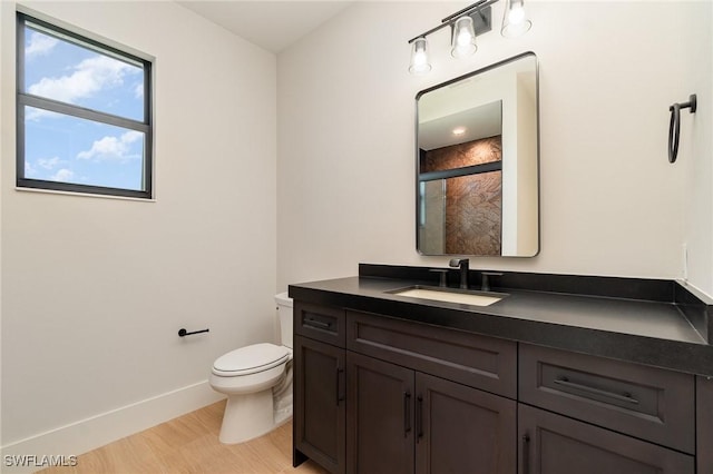 full bathroom featuring a shower with door, toilet, vanity, wood finished floors, and baseboards