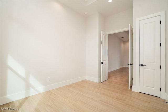 unfurnished room with light wood-style floors and baseboards