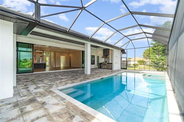 pool featuring a lanai, exterior kitchen, and a patio