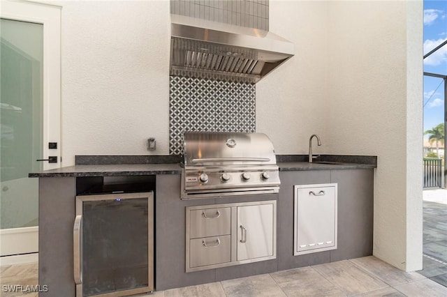 view of patio with a sink, exterior kitchen, and a grill