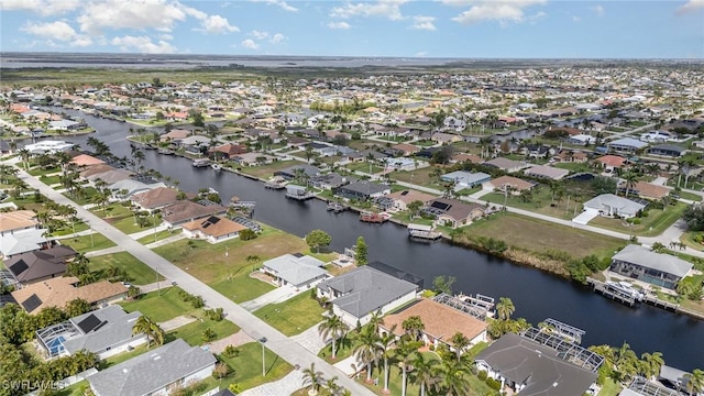 drone / aerial view with a water view and a residential view