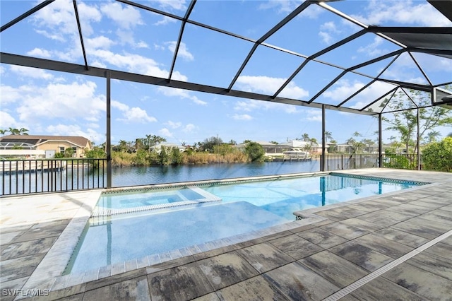 view of pool with a lanai, a water view, a pool with connected hot tub, and a patio area