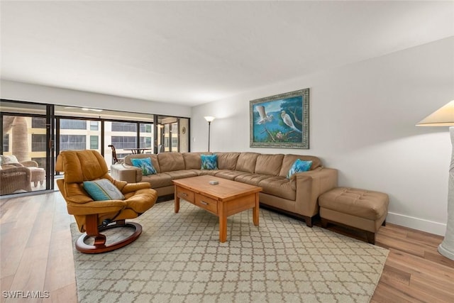 living room with light wood-style floors and baseboards