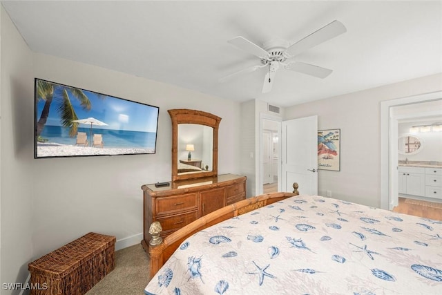 bedroom with connected bathroom, baseboards, visible vents, and ceiling fan