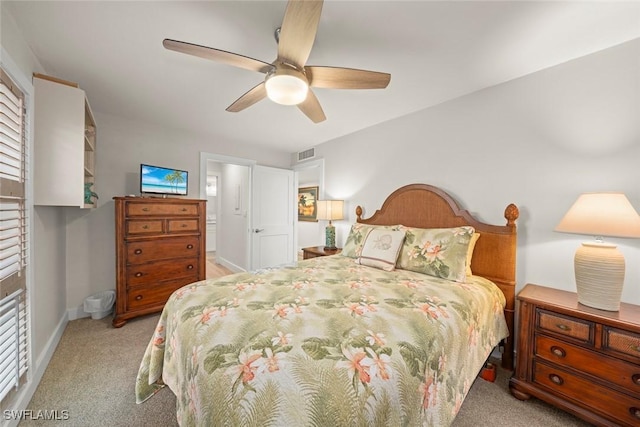 carpeted bedroom featuring visible vents, a ceiling fan, and baseboards