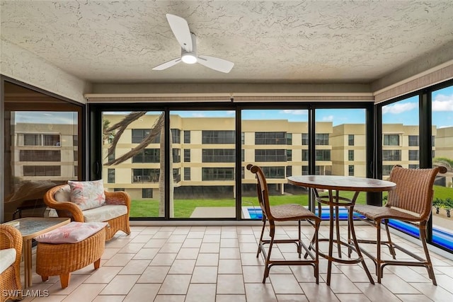 sunroom / solarium with ceiling fan