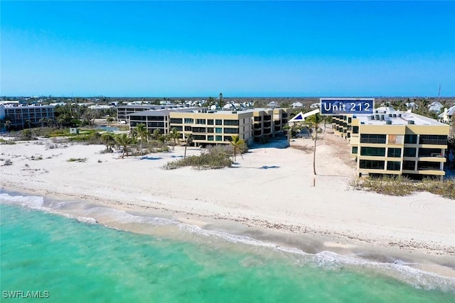 drone / aerial view with a water view and a view of the beach