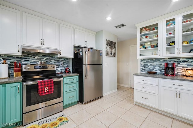 kitchen featuring under cabinet range hood, visible vents, white cabinetry, appliances with stainless steel finishes, and glass insert cabinets