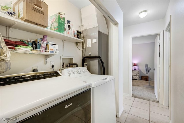 clothes washing area with laundry area, light tile patterned flooring, and independent washer and dryer