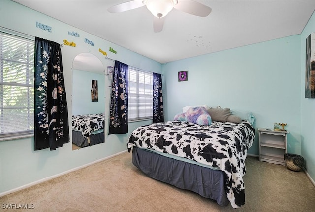 bedroom featuring carpet floors, baseboards, and a ceiling fan