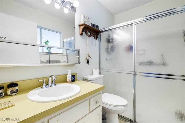 full bath with toilet, a shower with door, and vanity