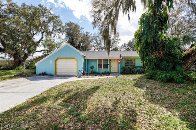 ranch-style home with a garage, driveway, a front yard, and stucco siding